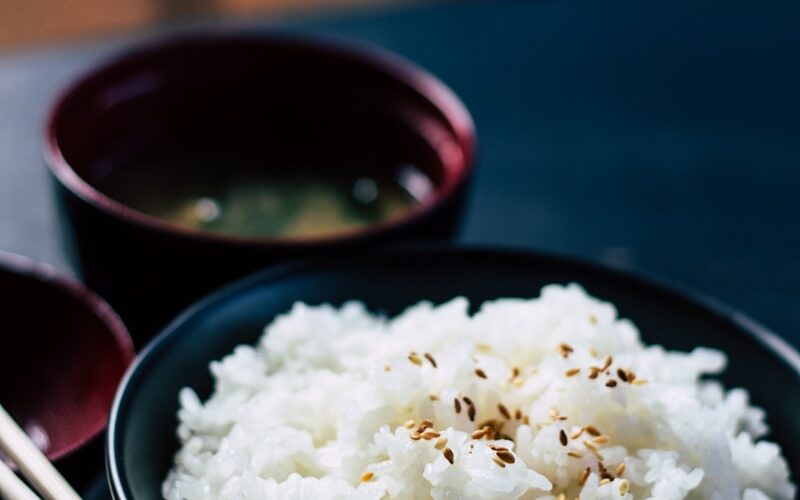 rice with sesame in black bowl